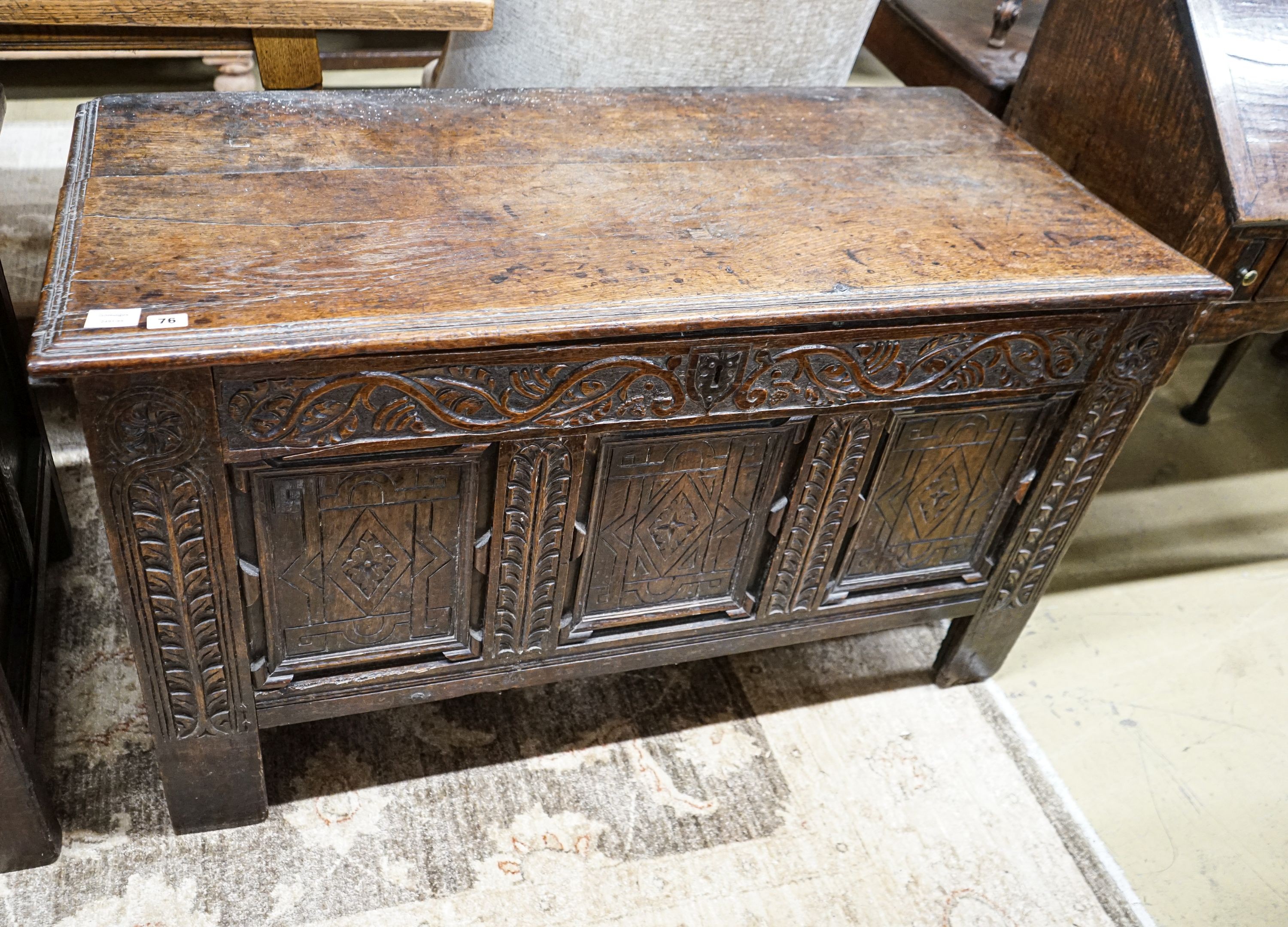 A 17th century oak coffer, with later carved front, length 120cm, depth 56cm, height 69cm